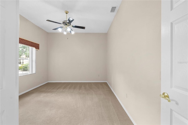 empty room featuring ceiling fan and light carpet