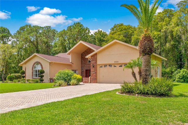 view of front of property with a front yard and a garage