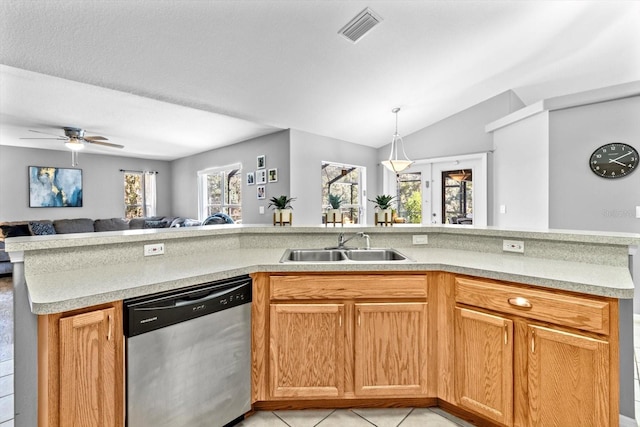 kitchen with a sink, visible vents, open floor plan, light countertops, and stainless steel dishwasher