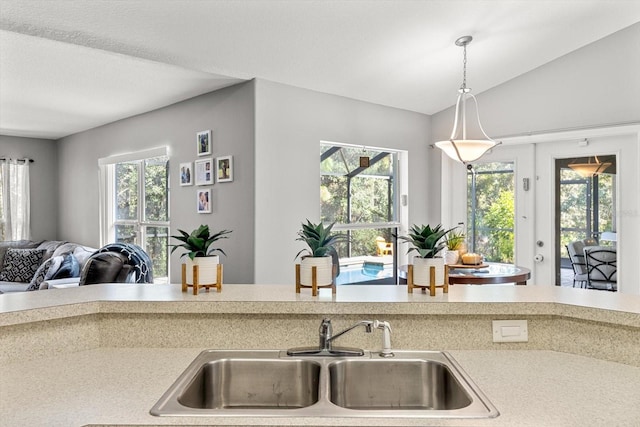 kitchen with plenty of natural light, open floor plan, a sink, and light countertops