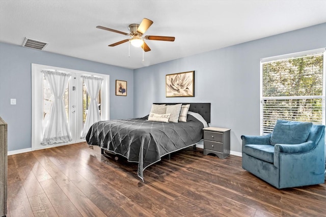 bedroom featuring visible vents, baseboards, ceiling fan, wood finished floors, and access to exterior