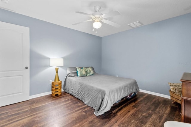 bedroom featuring visible vents, baseboards, ceiling fan, and wood finished floors