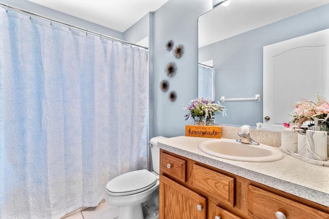 bathroom with toilet, tile patterned floors, and vanity