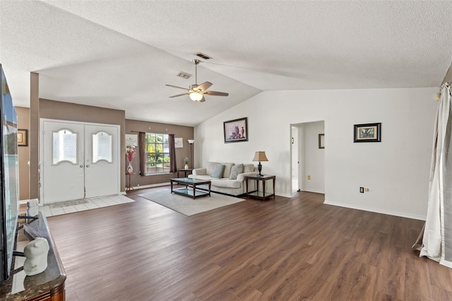 unfurnished living room featuring vaulted ceiling, ceiling fan, dark hardwood / wood-style floors, and a textured ceiling