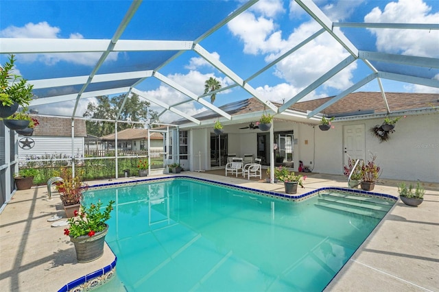 view of pool featuring a lanai, ceiling fan, and a patio area