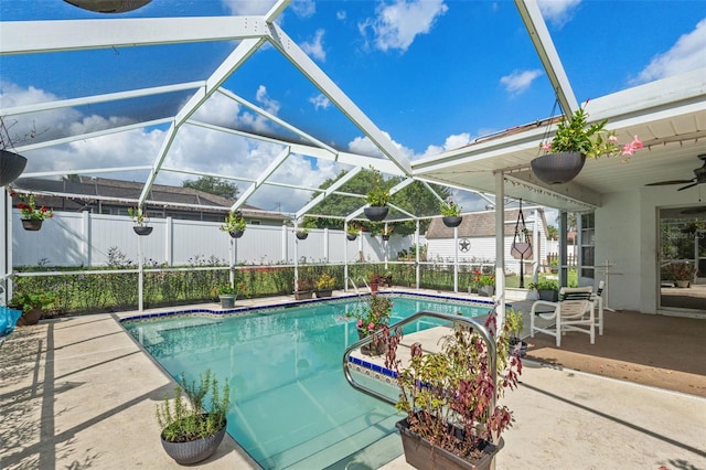 view of swimming pool with a lanai, a patio, and ceiling fan