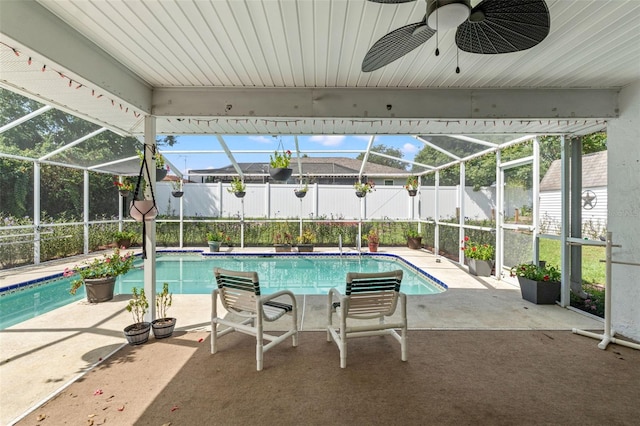 view of swimming pool featuring a patio, a lanai, and ceiling fan