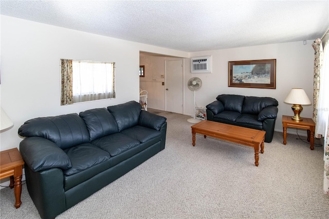 living room featuring a textured ceiling, carpet floors, and a wall mounted air conditioner