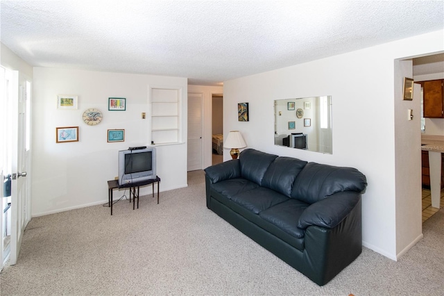 living room featuring light carpet and a textured ceiling