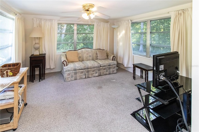 carpeted living room with ceiling fan