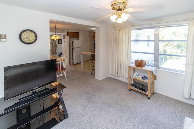 interior space with ceiling fan and light colored carpet