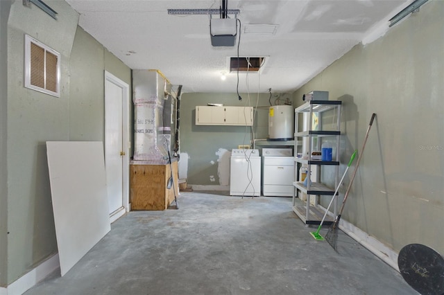 garage featuring washer and clothes dryer, a garage door opener, and water heater