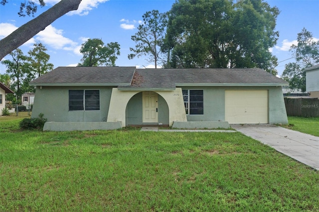 ranch-style house with a garage and a front yard