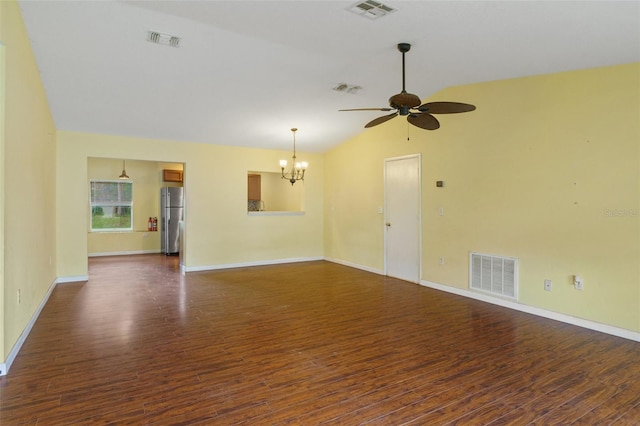 unfurnished room with ceiling fan with notable chandelier, vaulted ceiling, and dark hardwood / wood-style flooring