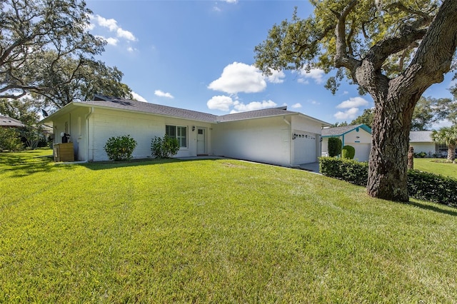 single story home with a garage and a front lawn