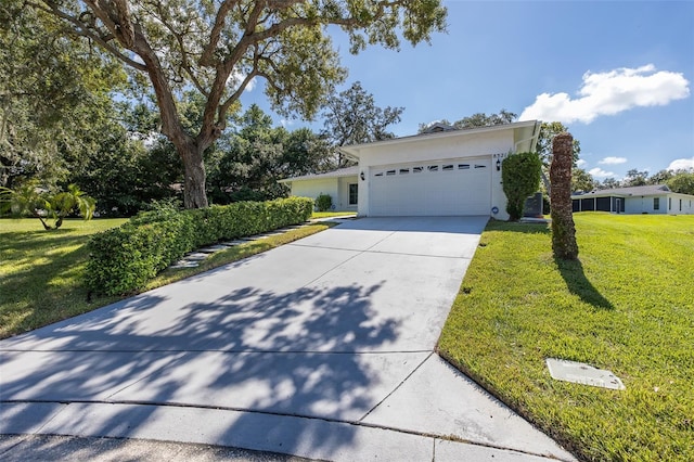 view of front of property featuring a front lawn and a garage