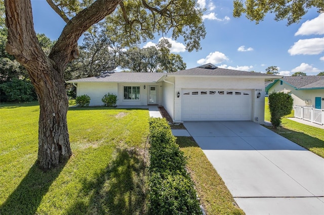 ranch-style home with a front yard and a garage