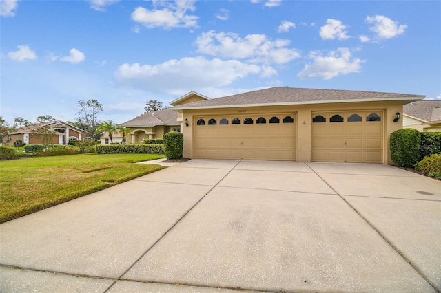 view of front of property featuring a garage and a front yard