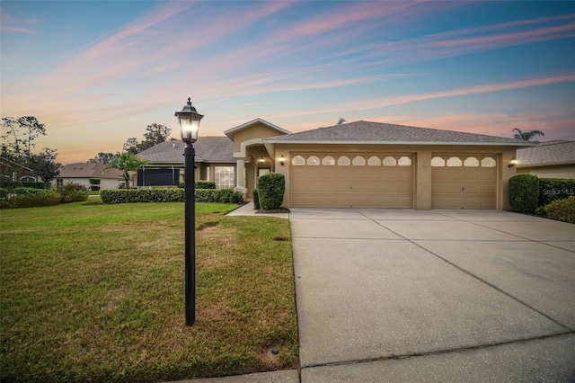 view of front of property with a lawn and a garage