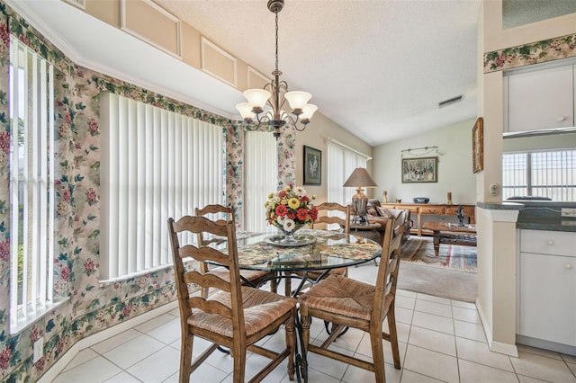 tiled dining area with a textured ceiling, lofted ceiling, and a notable chandelier