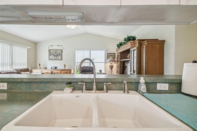 kitchen featuring sink and vaulted ceiling