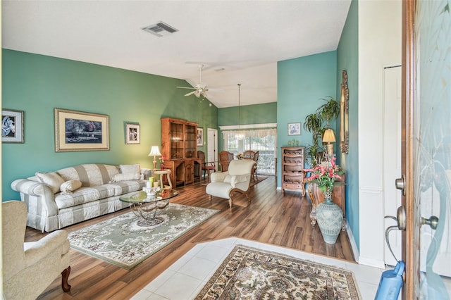 living room with light hardwood / wood-style flooring and ceiling fan