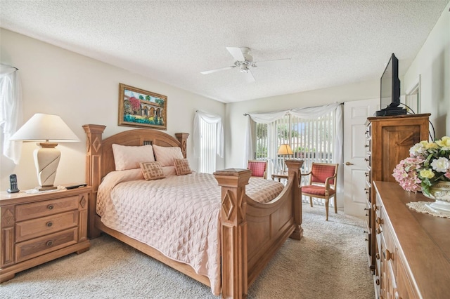 carpeted bedroom with a textured ceiling and ceiling fan