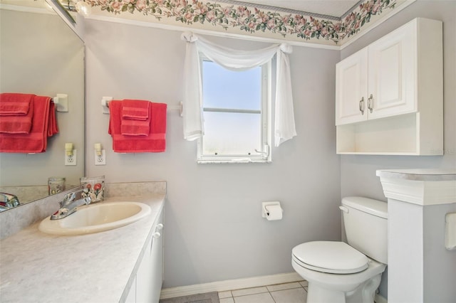 bathroom with toilet, vanity, and tile patterned floors