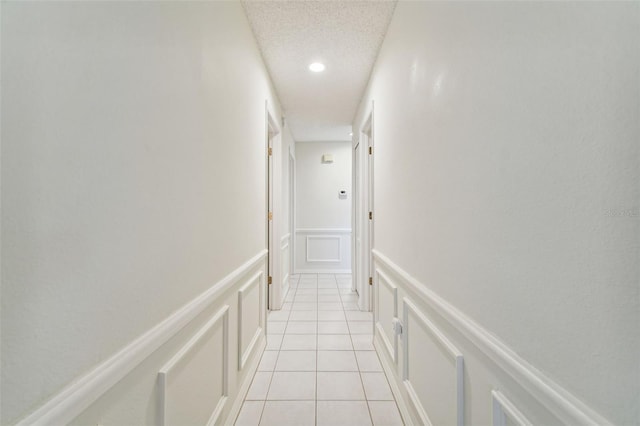 corridor featuring light tile patterned flooring