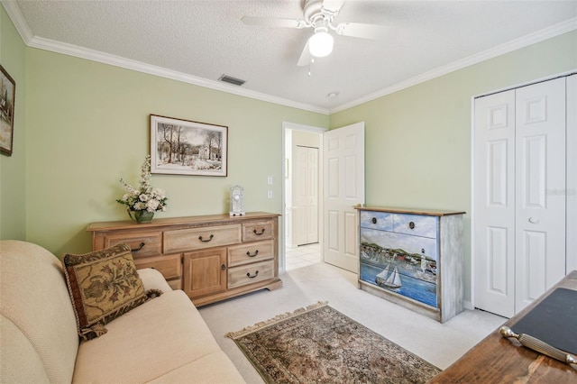 carpeted living room with a textured ceiling, ceiling fan, and crown molding