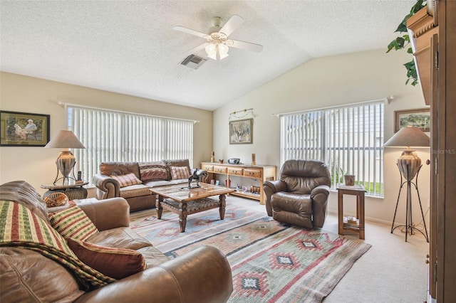 carpeted living room featuring ceiling fan, a textured ceiling, and lofted ceiling