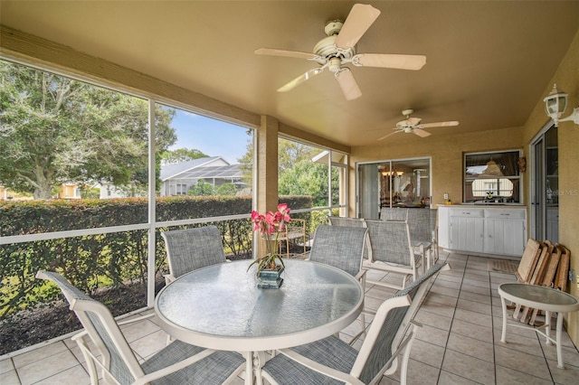 sunroom featuring ceiling fan