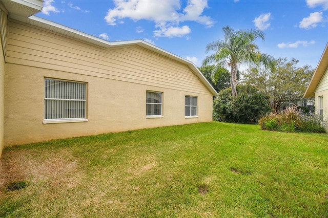 view of property exterior with a yard