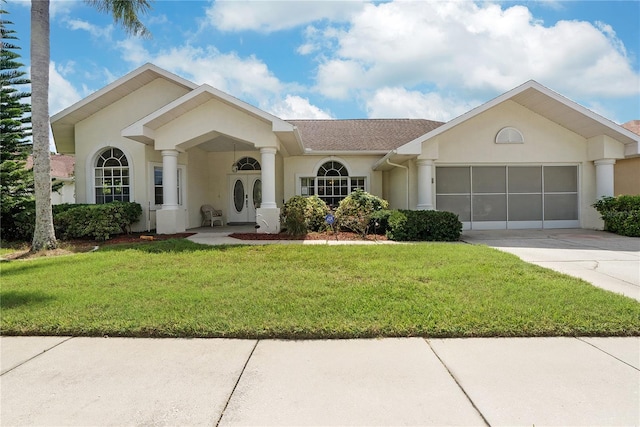 ranch-style house with a garage and a front lawn