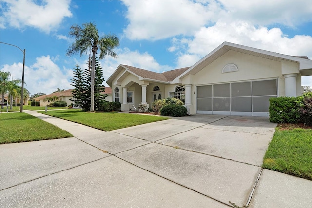 ranch-style home featuring a front lawn and a garage