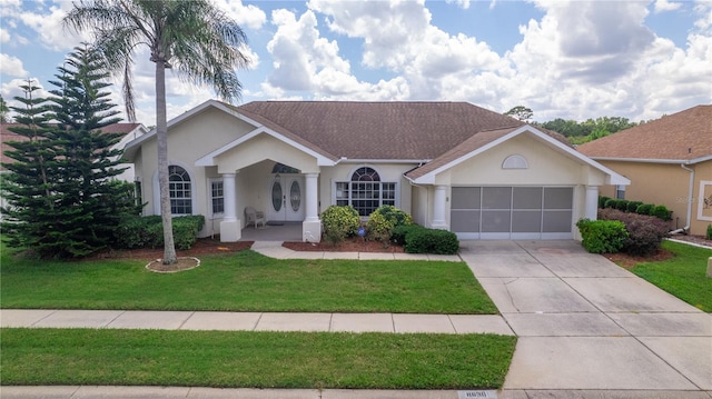 ranch-style home with a front yard and a garage