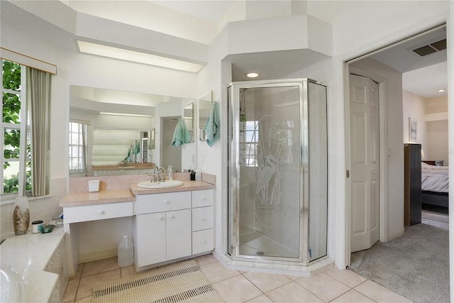 bathroom featuring vanity, tile patterned flooring, and a shower with door