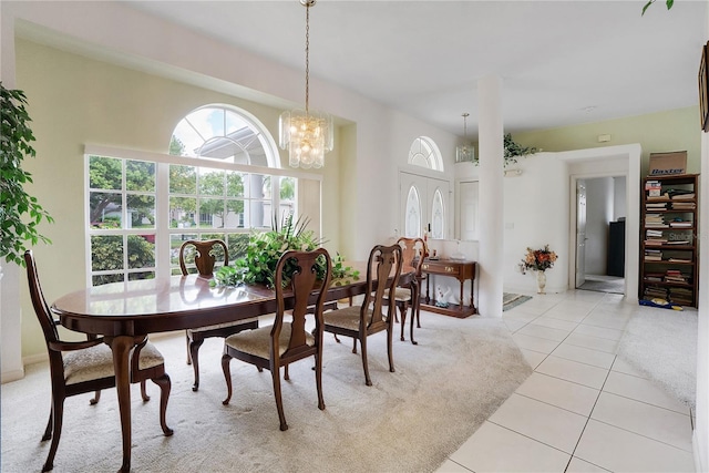 dining room with a notable chandelier and light tile patterned floors