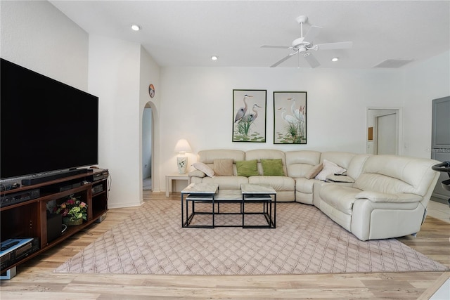 living room with light wood-type flooring and ceiling fan