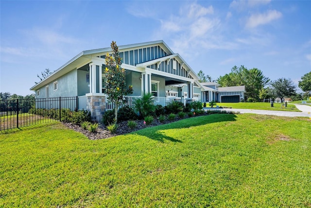 view of side of property featuring a lawn and a porch