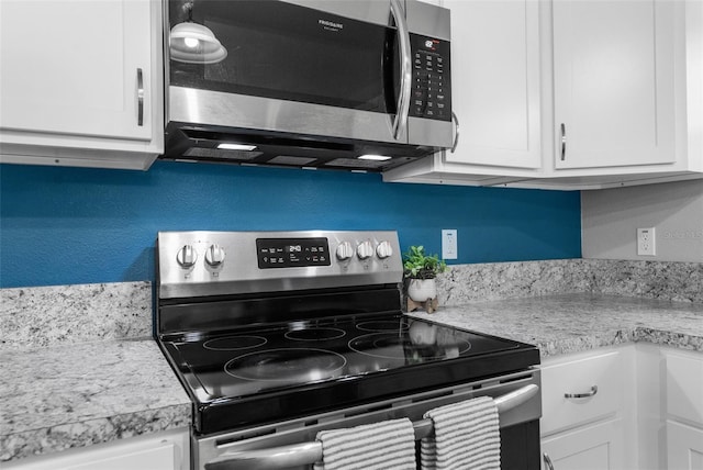 kitchen featuring white cabinets and appliances with stainless steel finishes