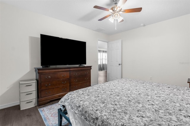 bedroom featuring ceiling fan and dark wood-type flooring