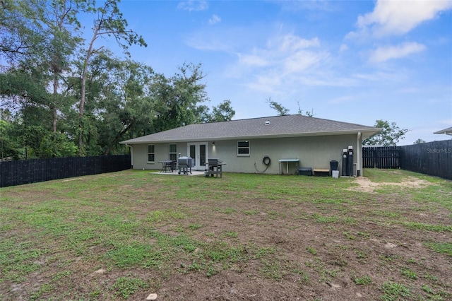 rear view of house featuring a patio and a yard