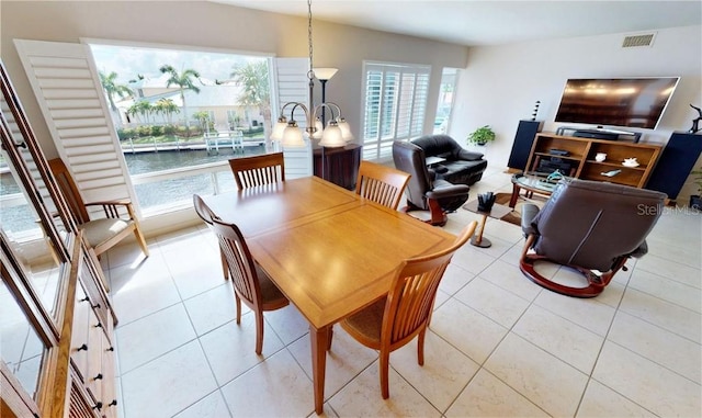 dining space with light tile patterned floors and a healthy amount of sunlight