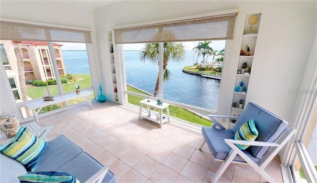 sunroom / solarium with a water view and a wealth of natural light