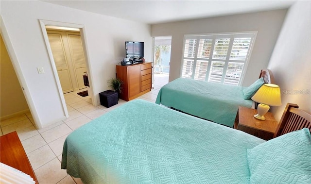 bedroom with light tile patterned floors