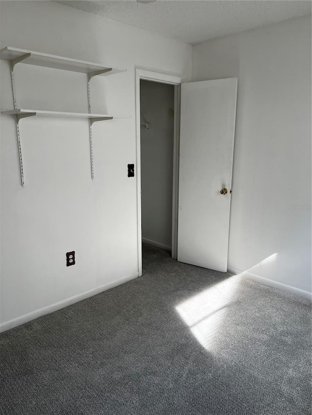 unfurnished bedroom featuring carpet and a textured ceiling