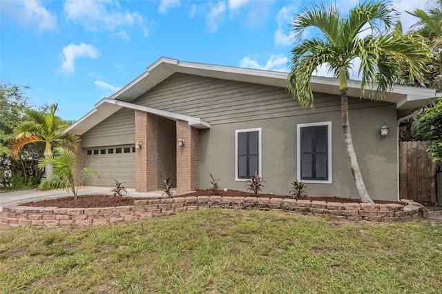 view of front of home featuring a garage and a front yard