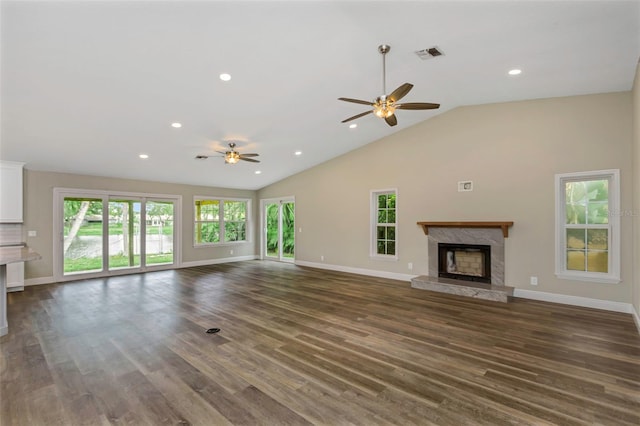 unfurnished living room with high vaulted ceiling, dark hardwood / wood-style flooring, ceiling fan, and a high end fireplace