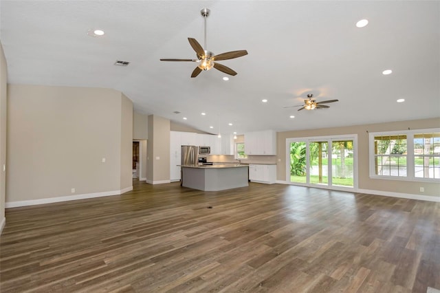 unfurnished living room featuring dark hardwood / wood-style flooring, high vaulted ceiling, and ceiling fan